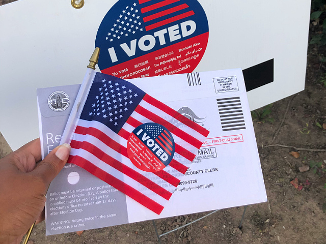 Voting booth vote ballot polling place american flag janine robinson unsplash